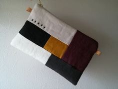 a piece of cloth hanging from a hook on a wall with other items in it