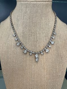 "This elegant rhinestone choker necklace is marked GARNE JEWELRY on the back of the box clasp.  The various size rhinestones are all present with prong settings. This mid century choker would be a wonderful addition to any vintage jewelry collection.  The Garne jewelry company was based in New York City and produced their line from 1945 to the late 1960's.  Measurement- 15.25\" x .75\" Item will be gift wrapped green of charge.  Free ship eligible with a $35 purchase." Classic Crystal Necklace With Rhinestones, Classic Crystal Rhinestone Necklace With Diamond Accents, Classic Rhinestone Necklace With Diamond Accents, Classic Silver Rhinestone Necklace, Formal Rhinestone Choker With Sparkling Stones, Formal Crystal Choker With Rhinestones, Formal Sparkling Rhinestone Choker Necklace, Vintage Rhinestone Adjustable Necklace, Classic Evening Necklaces With Rhinestones