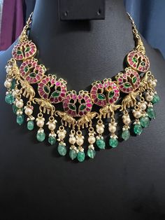 Jadau Kundan Jewelry Kemp Peacock Necklace/Gold Finish Ruby Pink Emerald Stone /Hand Made Mint Green Pearl Beads Drop/South Indian Jewelry DETAILS: Includes One Necklace Only Necklace:21.0 total 21 inches Long  Chin . Adjustable length. Hook Chain closure. Weighs  3.70oz ( 105 g) Material: Imitation Gold Finish pearls, Ruby Emerald Kundan  Red Stones .  Finish: Premium gold finish.  NOTE: I try my best to show you photos of my products as they appear in real life, but please note that variations Elegant Kundan Temple Necklace With Peacock Design, Green Necklace With Peacock Design For Celebrations, Peacock Design Necklace For Wedding, Wedding Necklace With Peacock Design In Peacock Color, Green Beads Indian Jewellery Gold, Wedding Necklace With Peacock Design, Multicolor Kundan Necklace With Peacock Design, Festive Multicolor Peacock Design Necklace, Luxury Kundan Necklace With Peacock Design