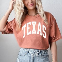 "FREE SHIPPING IN THE US! No order minimum!  Texas Shirt, Texas Tshirt, Comfort Colors Texas Shirt, Trendy Texas Shirt, Vintage Texas Shirt, Texas Gift, Gift for Texas Fan, Texas ♥ The SHIRT  * This is a Comfort Colors 1717 shirt.  * This unisex t-shirt is intended to be loose/oversized for women to give a chic and laid back vibe. If you are looking for an oversized \"T-shirt Dress\" look, we recommend sizing up 2-3 sizes.  * Detailed sizing information can be found in the size chart in the photos.  * Printed in the USA. ♥ CARE  ＊Machine wash cold, inside-out, gentle cycle ＊Wash with mild detergent and similar colors ＊Tumble dry low or hang-dry ＊Do not bleach or fabric softeners ＊Do not iron directly onto the design ＊Do not dry clean ♥ PRODUCTION & SHIPPING ＊Each shirt is made to order. ＊P College Tops With Text Print And Relaxed Fit, Relaxed Fit Text Print Top For College, Text Print Relaxed Fit Tops For College, College Text Print Top With Relaxed Fit, College Graphic Print Relaxed Fit Shirt, Summer College Shirt With Letter Print, College Graphic Tee With Short Sleeves, Graphic Tee With Short Sleeves For College, Relaxed Fit Screen Print Tops For College