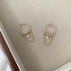 "These Chain hoop earrings are made from 14k gold-fill, and feature a small freshwater pearl, gold filled beads and a hanging figaro chain. ----------------------------------------------------- >> Material: 14k gold filled hoops ,beads and chain; freshwater pearl >> Pearl Size: Approx. 3-3.5mm >> Hoop Diameter: 15mm >> Sensitive skin friendly & tarnish resistant ------------What is Gold-filled---------------- Most of our findings and wires are made with 14k gold filled. \"Gold-filled\" is a USA industry standard that legally requires 5% pure gold by weight. It is a solid layer of gold bonded to another metal through heat and pressure. It does not wear off or turn colours over time, and if taken care of properly it can last a lifetime. Gold-filled jewellery is a cheaper, yet the best altern 14k Gold Filled Hoop Earrings With Pearl Charm, Everyday 14k Gold Filled Pearl Chain Earrings, Gold-plated Dangle Hoop Earrings With Pearl Charm, Gold Hoop Pearl Earrings Nickel Free, Gold Plated Dangle Hoop Earrings With Pearl Charm, Dainty Gold Hoop Pearl Earrings, Hypoallergenic Yellow Gold Pearl Hoop Earrings, Dainty Yellow Gold Hoop Earrings With Pearl, Gold Hoop Pearl Earrings With Ear Wire