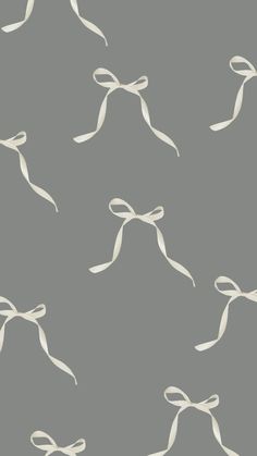 a gray background with white bows on it