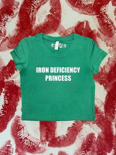 "Crop top with \"Iron Deficiency Princess\" - design printed on a 95% cotton 5% spandex, form fitting, available in multiple colors 💞 Make sure to check the size chart!✨ Message me with any questions :)  we do not give refunds for incorrect addresses so please double check that all your information is correct before ordering" Y2k Green Tops For Streetwear, Green Y2k Style Top For Streetwear, Y2k Green Top For Streetwear, Y2k Green Graphic Print Tops, Green Graphic Print Y2k Tops, Green Y2k Graphic Print Tops, Crop Tops With Words, Green Y2k Stretch T-shirt, Y2k Green Tops With Screen Print