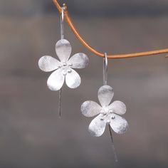 Radiant and delicate jasmines shine in these dainty threader earrings presented by Desi Antari. Balinese artisans give these floral-themed sterling silver earrings a brushed-satin finish making them the perfect accessory for any day out. Luxury Handmade Silver Danglers, Cheap Silver Metal Danglers, Cheap Elegant Metal Earrings, Simple Silver Earrings Flower, Silver Jewelry Dangles, Small Flower Earrings, Jewellery Inspiration, Sterling Silver Drop Earrings, Classic Earrings