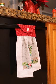 the kitchen towel is hanging on the dishwasher