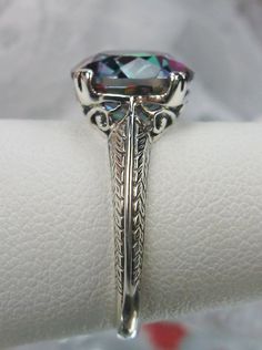 "Natural Mystic Topaz Ring Design#12 Custom This is an Art Nouveau/Deco reproduction ring in sterling silver set with a stunning 3.8ct natural mystic/rainbow topaz gemstone. The round full cut mystic topaz is 10mm in diameter (3/8th\"). The inside of the band is marked 925 for sterling (or 10k, 14k if chosen). Notice the beautiful craftsmanship of the silver filigree setting. This is an exquisite rendition of an antique style of ring... and is ready to wear. A gift box is included and the ring w 1930's Style, Art Deco Filigree, Rainbow Topaz, Mystic Topaz Ring, Vintage Style Rings, Mystic Topaz, Engraved Items, Silver Filigree, Topaz Gemstone