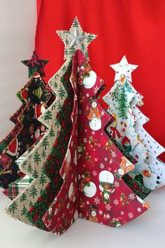 three christmas trees made out of folded paper