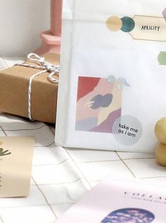 there is a small gift bag on the table next to some cards and a rubber duck