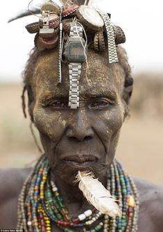 an old woman with feathers and beads on her head