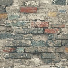 an old brick wall that has been painted red and blue