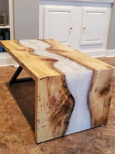 a table made out of wood with white fur on it