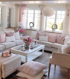 a living room filled with lots of white furniture