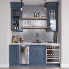 a kitchen with blue cabinets and stainless steel appliances in the center, along with wine glasses on shelves