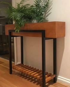 a plant is sitting on top of a wooden shelf