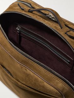 Inspired by vintage flight styles, Métier's 'Wanderer' messenger bag combines the look of a traditional briefcase with the functionality of luggage. It's been made in Italy from smooth suede and has two interior compartments sized to fit the essentials, plus a 13-inch laptop, sunglasses and a change of clothes. Convert the back pocket into a trolley sleeve by unfastening the zipper along the bottom. Designer Travel Satchel With Zipper Pocket, Designer Satchel With Zipper Pocket For Travel, Designer Leather Satchel With Zipper Pocket, Luxury Rectangular Briefcase With Zipper Pocket, Rectangular Suede Business Bag, Luxury Brown Briefcase With Zipper Pocket, Brown Suede Business Bag, Modern Suede Satchel For Travel, Top Handle Suede Satchel For Travel