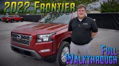 a man standing in front of a red truck with the words 2021 frontier on it