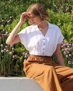 Linen crop top HAVASU in white is designed with lapels, elbow-length sleeves, and two front patch pockets, capturing the spirit of a camp shirt. Double seam details add a touch of sophistication, while white shell buttons down the front offer versatility, allowing it to be worn open as an overshirt. Details: * Tie-waist fit * Short length * Buttoned * Short dropped sleeves * Elastic at the bottom * Collar transitions into a V-neckline * Coconut button fastening at the front * Centre back length: White Cropped Shirt For Spring, Casual Cropped Blouse With Pockets, White Button-up Crop Top For Summer, White Collared Crop Top For Summer, White Cropped Shirt Relaxed Fit For Spring, Spring Cropped Blouse With Pockets, Cropped Linen Blouse For Day Out, Cropped Spring Blouse With Pockets, Casual Collared Crop Top For Spring