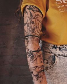 a person with tattoos on their arms and arm