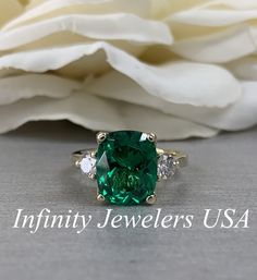 Emerald Engagement Ring, Elongated Cushion Emerald Ring With Moissanite Accents, May Birthstone Ring, Emerald Ring In 14K Yellow Gold #6720 #MayBirthstone #MoissaniteRing #EngagementRing #6720 #AnniversaryGift #14kYellowGold #EmeraldRing #InfinityJewelersUSA #LadiesRing #ElongatedCushion Luxury Gold Emerald Ring Birthstone, Luxury Gold Emerald Ring With Diamonds, Cushion Emerald Engagement Ring, Cushion Emerald Ring, Green Moissanite Emerald Ring In Fine Jewelry Style, Green Moissanite Emerald Ring For May Birthstone, Fine Jewelry Emerald Moissanite Ring, Green Moissanite Jewelry In Radiant Cut, Fine Jewelry Green Moissanite Emerald Ring