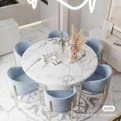 a marble dining table surrounded by blue chairs in a white and gold kitchen with an overhead chandelier