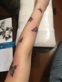 a woman's arm with butterflies on it