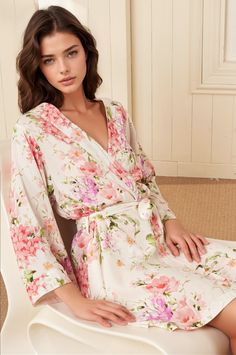 This elegant floral robe showcases an exclusive, romantic print on luxuriously soft, high-quality rayon. Meticulously designed for versatile wear, it’s the perfect addition to any woman's wardrobe. Whether used as a bridesmaid or bridal robe, a maternity robe, or as a stylish pool or beach cover-up, this robe is a one-of-a-kind keepsake. FABRIC: 100% Rayon LENGTH: Top of shoulder to hem 36" STYLE: PJ-18088 in SOFT KISS IVORY - SOFKI-P99 *Model is wearing size small *Machine was on cold, and hang Spring Wedding Sleepwear V-neck, V-neck Spring Wedding Sleepwear, Spring Wedding V-neck Sleepwear, White Floral Print Robe For Daywear, White V-neck Robe For Spring, White Floral Print V-neck Sleepwear, Spring V-neck Robe For Wedding Night, White Feminine Summer Robe, Elegant Floral Print V-neck Sleepwear