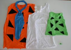 three different types of clothing are laid out on the floor, including one with a tie