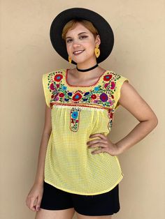 "Very rare and colorful traditional Mexican top with a twist. The gingham fabric gives the perfect modern touch that you need! Totally hand-embroidered, definitely you will be the center of attention wherever you go. Fall in love with this Picnic outfit. Loose fit Yellow and white gingham, colorful floral embroidery. Fits size SMALL Measurements taken flat: Armpit to armpit 18 1/2\" Bottom hem width 23\" Shoulder to bottom hem 25\"" Gingham Tops For Beach In Spring, Yellow Folk Style Blouse For Spring, Yellow Folk Style Spring Blouse, Multicolor Peasant Blouse For Summer, Summer Gingham Fitted Blouse, Spring Folk Style Tops For Vacation, Summer Fitted Gingham Blouse, Spring Folk Beach Tops, Folk Style Tops For Spring Vacation