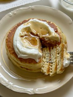 a plate with pancakes covered in butter and syrup