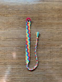 a colorful rope on top of a wooden table