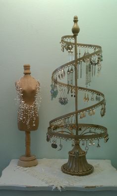 there is a jewelry tree next to a mannequin