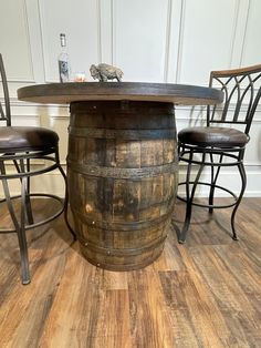 a wooden barrel table with three chairs around it