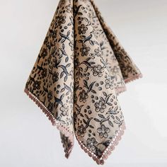 an animal print scarf hanging from a hook