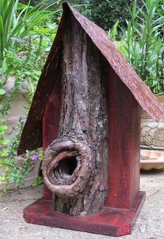 a bird house made out of tree trunks