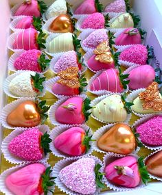 a box filled with lots of pink and white chocolate covered in sprinkles