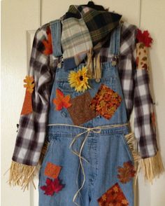 a child's overalls with fall decorations on it