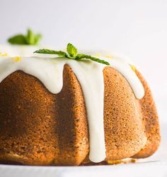 a bundt cake with white icing and green leaves on top