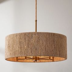 a light fixture hanging from the ceiling in a room with white walls and flooring