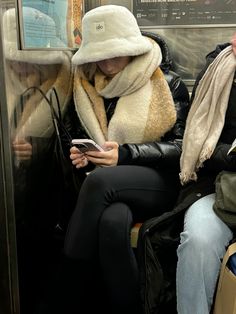 Winter style, nyc subway, cold weather fit, blanket scarf, aritzia suoer puff, alo bucket hat, legwarmers Shearling Bucket Hat Outfit, Ugg Bucket Hat Outfit, Fluffy Bucket Hat Outfit Winter, Fleece Bucket Hat Outfit, Styling Bucket Hat Women, Sherpa Bucket Hat Outfit, Fluffy Hat Outfit, Bucket Hat Winter Outfit, Park City Outfits