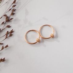 Simple and dainty gold hoop earrings, 14k Gold filled, Trend now, christmas gift for her  Modern, timeless and beautiful!  Our 14ct gold filled hoops are a minimal classic.  So light and comfortable that you could wear it all day!  When running, showering, sleeping, playing and creating, they do not have to be discarded!  You own yourself as a wonderful everyday companion.  Materials:  1 pair of earrings  14mm diameter  14k gold filled  2 sparkling pearls  Stardust, flat, dented  4mm diameter  1 Gold Simple Design Huggie Jewelry, Gold Huggie Jewelry With Simple Design, Dainty Yellow Gold Hoop Earrings Gift, Hypoallergenic Gold Cartilage Earrings As Gift, Hypoallergenic Gold Cartilage Earrings For Gift, Dainty Gold Huggie Earrings For Gift, Small Hoop Gold Cartilage Earrings As Gift, 14k Gold Filled Gold Cartilage Earrings, Tarnish Resistant 14k Gold Filled Cartilage Earrings For Gift