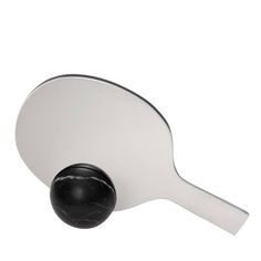 a ping pong paddle with a black ball on it's side and a white background