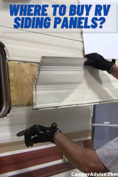 a man is working on the side of a trailer that has siding panels attached to it