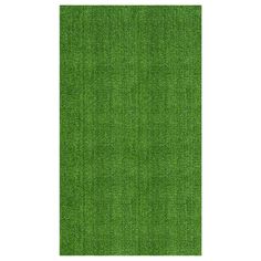 an area rug with green grass