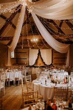 the inside of a wedding venue with tables and chairs