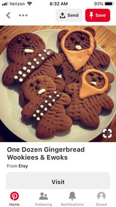 some cookies are on a white plate and have icing in the shape of bears