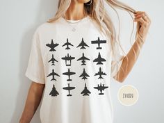 Take your love for aviation to new heights with this unisex Comfort Colors t-shirt, featuring a range of airplane silhouettes from sleek fighter jets to iconic commercial planes. Perfect for aviation enthusiasts, pilots, and jet fighter fans, this soft tee makes a bold statement. Whether you're soaring in the skies or grounded, it's a must-have for any airplane lover! .: 100% ring-spun cotton .: Medium fabric (6.1 oz/yd² (206.8 g/m .: Relaxed fit .: Sewn-in twill label .: Runs true to size For the oversized look, we recommend going up one or two sizes from your regular fit for a relaxed and roomy feel. To ensure the longevity and vibrant appearance of your item, please follow these care instructions: - Turn garment inside out for washing and drying - Machine wash cold only (on delicate cyc Airplane Silhouette, Washing And Drying Machine, Commercial Plane, Pilot T Shirt, Merch Ideas, Jet Fighter, Comfort Colors Tshirt, Drying Machine, Military Aviation