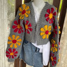 a crocheted sweater with flowers on it