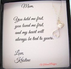 a mother's necklace in a box with the message mom you held me first, you loved me first, and my heart will always be tied to yours