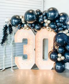 a large balloon arch with the number 50 surrounded by balloons