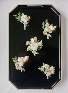 a black tray with white flowers on it